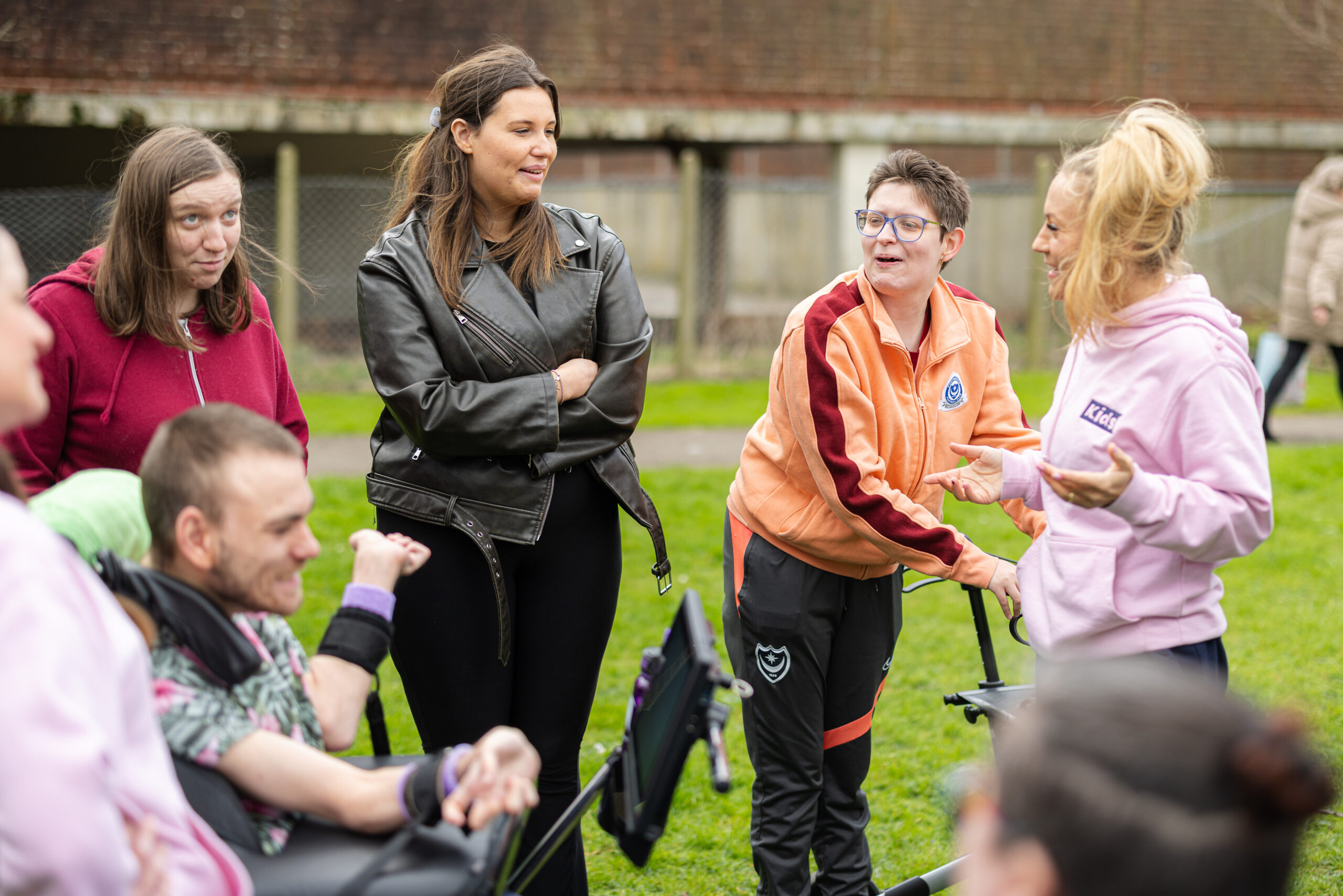 a group of young people smiling and chatting