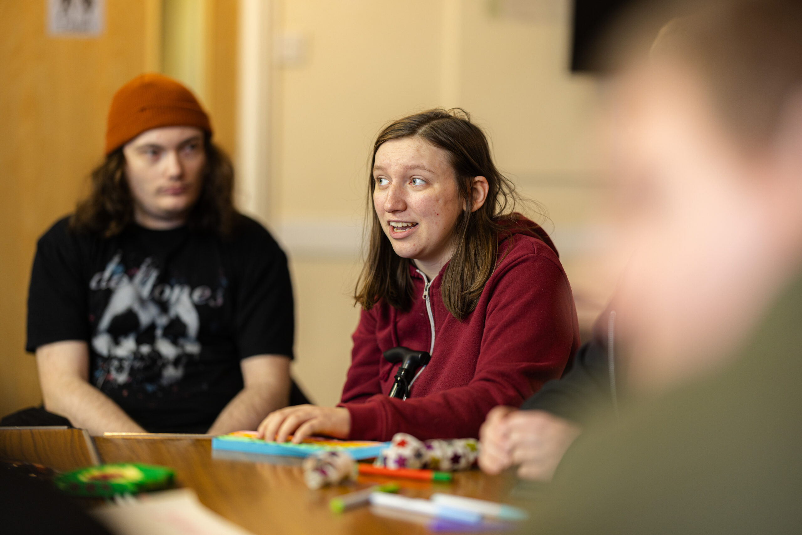 young people with SEND talking whilst sitting at a table