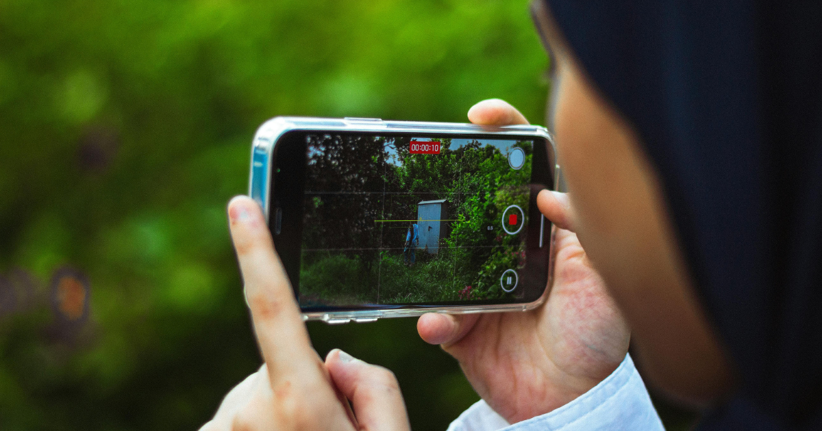 teenager videoing outside with a phone